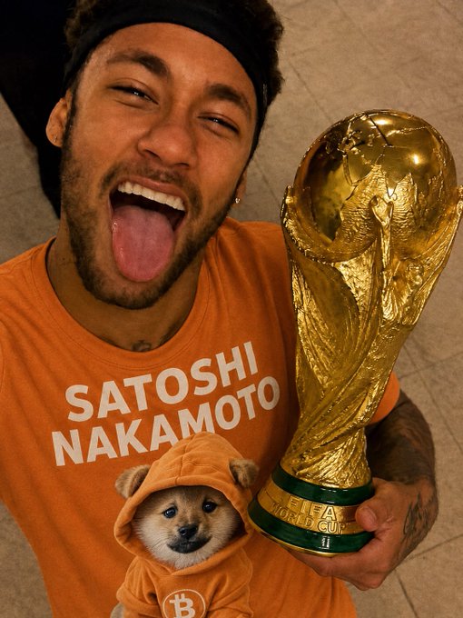 A man celebrating with the FIFA World Cup trophy while wearing an orange shirt reading 'SATOSHI NAKAMOTO' featuring a Shiba Inu dog in a hoodie.