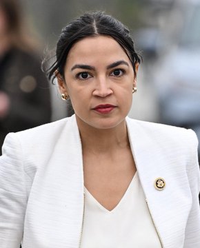 A serious-looking woman in a cream-colored blazer with a gold pin stands outdoors, likely a politician or public figure, whose composed expression contrasts with the triumphant tone of the post celebrating a market rebound with "we up now."