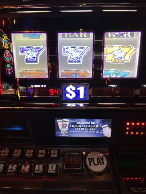 A slot machine displays a winning combination on its reels, showing a $1 payout with 94 credits and a Golden Nugget Sports app advertisement.