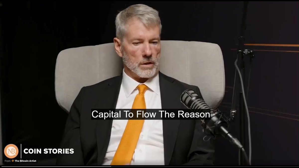 The image features a man wearing a suit, sitting in an office chair with his back facing the camera. He has a microphone behind him, suggesting that he might be hosting or participating in a podcast or interview. The text "Capital To Flow The Reason" is written on the image, which appears to be related to the content of the post about Bitcoin and Saylor's investment strategy.