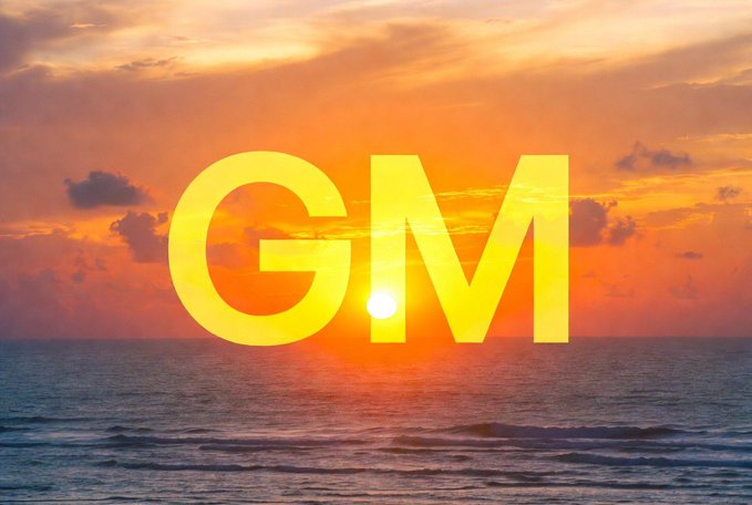 A vibrant sunset over the ocean with bright orange and yellow colors, featuring the letters 'GM' (Good Morning) in large yellow text overlaid on the scene.