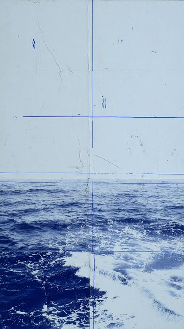 A minimalist seascape divided by blue crosshairs, showing deep blue ocean waves with white foam at the bottom and a blank, scratched pale sky above—evoking "north wave" by framing the horizon as if viewed through a targeting lens, fitting the artwork's 0.055 ETH listing on SuperRare.