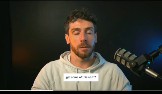 A man with closed eyes wearing a light grey hoodie speaks into a microphone, with the on-screen caption reading 'get some of this stuff?'.