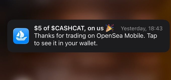 A notification from OpenSea Mobile awarding "$5 of $CASHCAT, on us" with a party popper emoji and timestamp "Yesterday, 18:43," thanking the user for trading on the app. The image illustrates the post's criticism that while long-time active users miss out on larger airdrops, OpenSea offers only a small $5 reward.