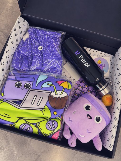 An open subscription box containing purple-themed merchandise including clothing, a plush octopus, and a Perpl-branded water bottle.