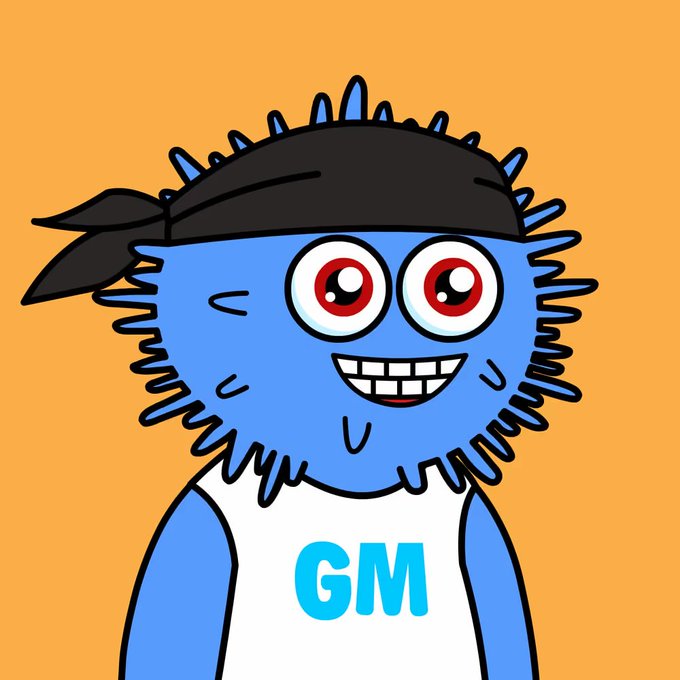 A cartoon blue furry mascot character with spiky hair, a black bandana, big red eyes, and a toothy smile, wearing a white tank top with 'GM' written in blue letters on an orange background.