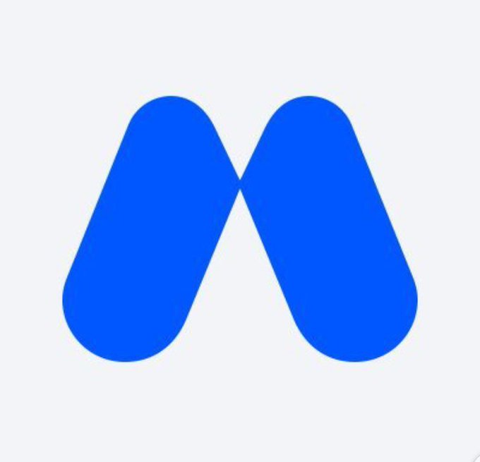 A simple blue logo consisting of two rounded shapes forming an 'M' design is displayed on a light gray background.
