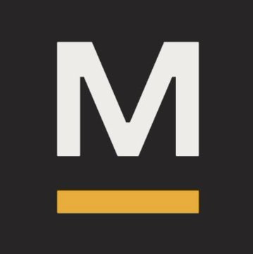 The image features a logo for an organization called Mining Giants. The logo consists of the word "M" in white letters, surrounded by gold bars. The text within the "M" includes the words "BREAKING" and "#BITCOIN". There is also a description that reads "Publicly traded mining giants are now buying the dip bottom is in", which implies that the Mining Giants company has made a significant financial investment in a particular industry, possibly related to precious metals like bitcoin.