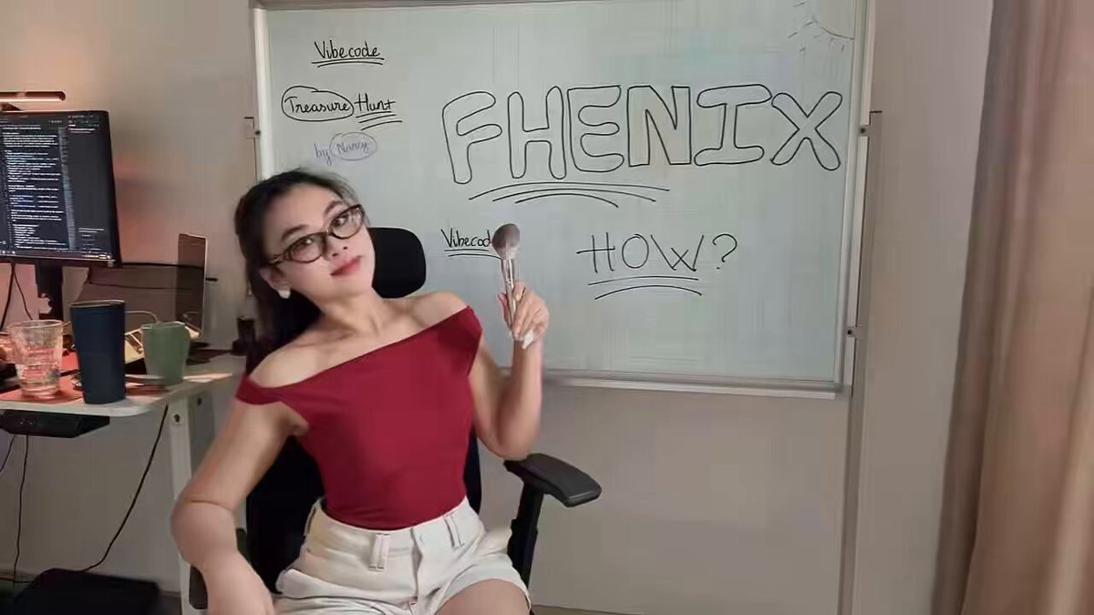 The image features a woman sitting at a desk with her arm raised, holding a spoon over a whiteboard that says "Fhenix How?". The woman appears to be wearing glasses and a red top as she poses for the photo. In the background, there is a computer monitor on the left side of the frame, suggesting that this might be an office setting or a workspace where the woman could be working on a project related to coding or technology.

The post includes text that reads "Who said a woman with a pretty face can't code? I'm just finished my first game using @fhenix technology aka <encrypted> the whole thing Full clip and tutorial version gonna be launched soon". This implies that the image is promoting an idea of inclusivity, encouraging women to pursue careers or hobbies related to technology.