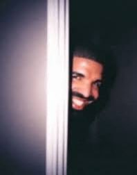 A blurry, motion-distorted image showing a person's face with glasses peeking around a corner or doorway.