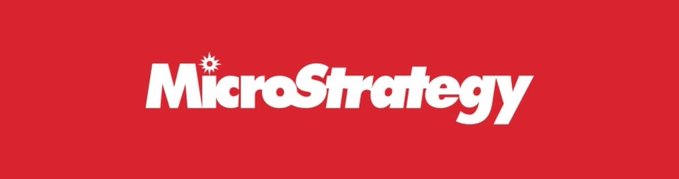 The image features a gray background with the words "MicroStrategy" written in white letters above a red line. The text is positioned at the top of the image, making it stand out against the gray backdrop. There are no other objects or texts present in the image.