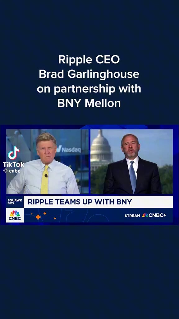 The image shows two men, one wearing a suit and tie and the other in a white shirt with a yellow tie, standing next to each other against a blue background. The text at the top of the image reads "Ripple CEO Brad Garlinghouse on CNBC: Pleased to partner with @BNYMellon as primary custodian for RLUSD". This suggests that they are discussing the partnership between Ripple and BNY Mellon, which is related to stablecoins and crypto.
