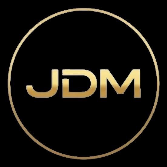 A minimalist logo featuring the letters "JDM" in gold gradient text inside a gold circle on a black background.