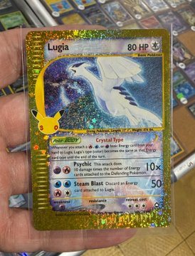 A holographic Lugia Pokémon trading card with 80 HP, featuring Pikachu stamps on the left side, held in a person's hand.