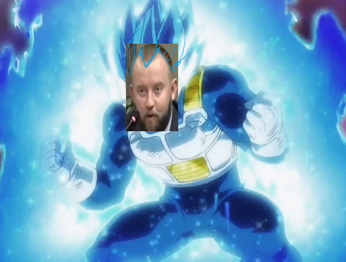 An anime-style illustration of Vegeta from Dragon Ball powering up with blue Super Saiyan energy, humorously edited with a photo of a bearded man's face (appearing to be a shocked reaction) pasted over Vegeta's head.