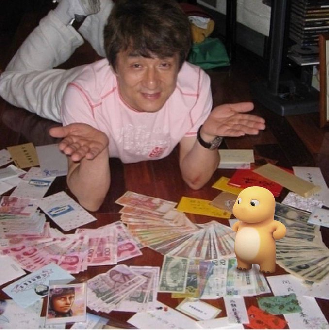 A man in a pink shirt kneels on a wooden floor surrounded by an extensive fan collection of letters, postcards, and foreign currency, with a small cartoon creature overlaid on the image.