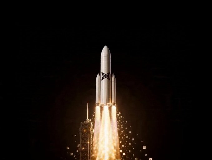 The image features a rocket launching into space with its flames flying out from behind it. The rocket is positioned at the center of the frame, creating a sense of motion as it ascends into the sky. In the background, there are two other rockets visible, one on each side of the main rocket. The text in the image reads "Good morning Legendz GM Can'T believe we're ~~2 months down on @quipnetwork, it's really amazing how consistency rules the whole game With the Quantum Echoes NFT WL LB on NucleusCodes already ended on 4 days ago, plus the Q2 launch narrative in play, I can't help but be".