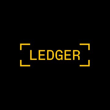 The image displays the Ledger logo—yellow text "LEDGER" framed by corner brackets on a black background—visually representing the company's brand as it announces its new self-custodial Bitcoin-backed lending service through Morpho.