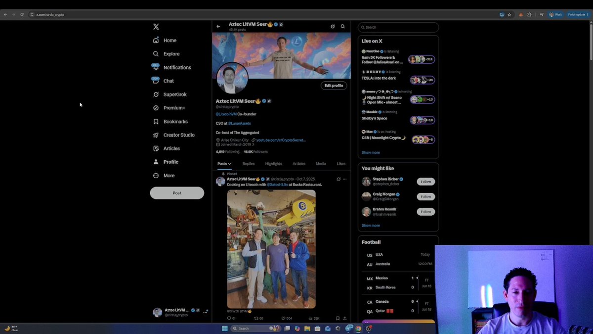 In this image, a man is sitting at his computer with a monitor displaying a Twitter page. The Twitter page features a photo of a group of people along with some text that reads "Focus on what is in the image and how it relates to the post". The main focus of the image seems to be the post about Litecoin and its supporters, who are actively working towards advancing the decentralized freedom movement by leading innovation.