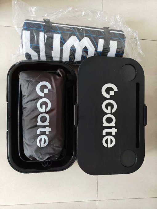 An open black GGmate branded case containing a gray storage bag, with a rolled-up Limk brand mat in plastic packaging placed on top.
