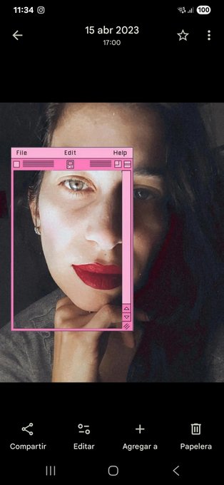 A mobile phone screenshot showing a photo of a woman with red lipstick, with the image portion framed by a pink retro computer window UI design titled 'File Edit Help.'