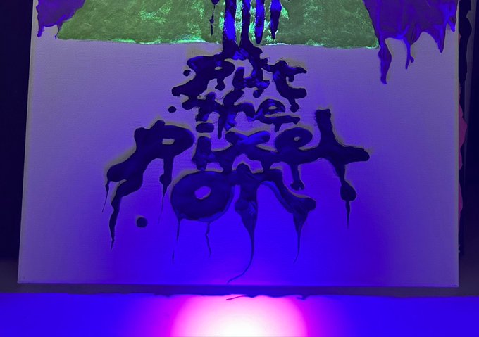 An abstract painting illuminated by purple light, featuring dripping dark shapes on a canvas with green accents at the top.