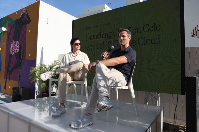 Two men seated on stage at an outdoor event with a green screen reading 'Launching U.S. on Celo with Self & Google Cloud'.