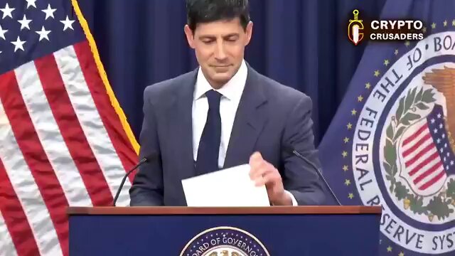 The image presents a man standing behind a podium, giving a speech or announcement while holding up an envelope with money inside, suggesting he may be discussing financial matters or sharing important information related to currency. The text in the image states that "THE XRP LEDGER PAYMET SYSTEM WILL GLOBALIZE AT A $4.1 TRILLION DOLLAR MARKET!! ON Augs 1ST THE TOP DEFI TOKEN WILL BE LISTED ON A GLOBAL CENTRALIZED EXCHANGE!!! UNLOCKING $4.1 TRILLION INTO ITS MARKET PROPERLY!! I GOT A BAG BUY REAL TOKEN ON DEX:".