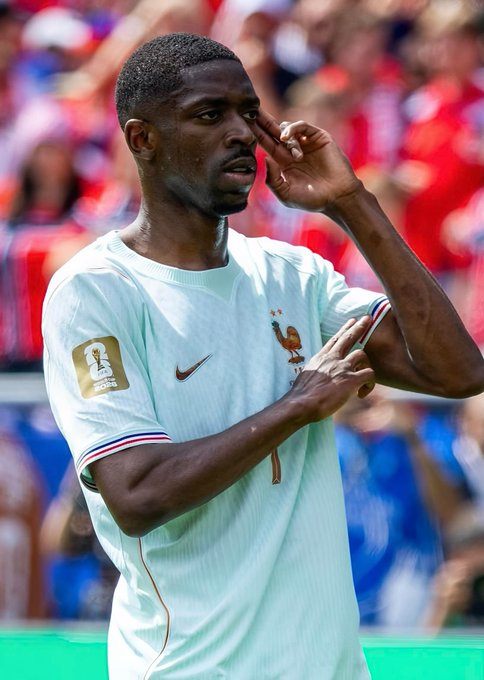 A soccer player in a light blue France national team jersey (number 7) making a gesture near his eye during what appears to be a 2025 World Cup match.