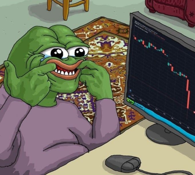 The Pepe the Frog meme character forces a wide, tearful grin while staring at a sharply declining red candlestick chart on his computer monitor, perfectly embodying the "smile through the pain" sentiment of enduring crypto market losses.