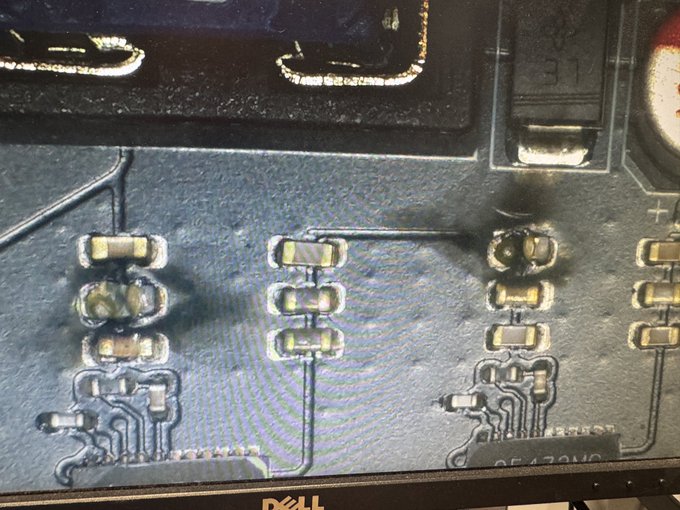 A close-up microscope view of a damaged circuit board reveals broken surface-mount capacitors and torn PCB traces, consistent with the post's description of a faulty BM1373 ASIC miner requiring repair.