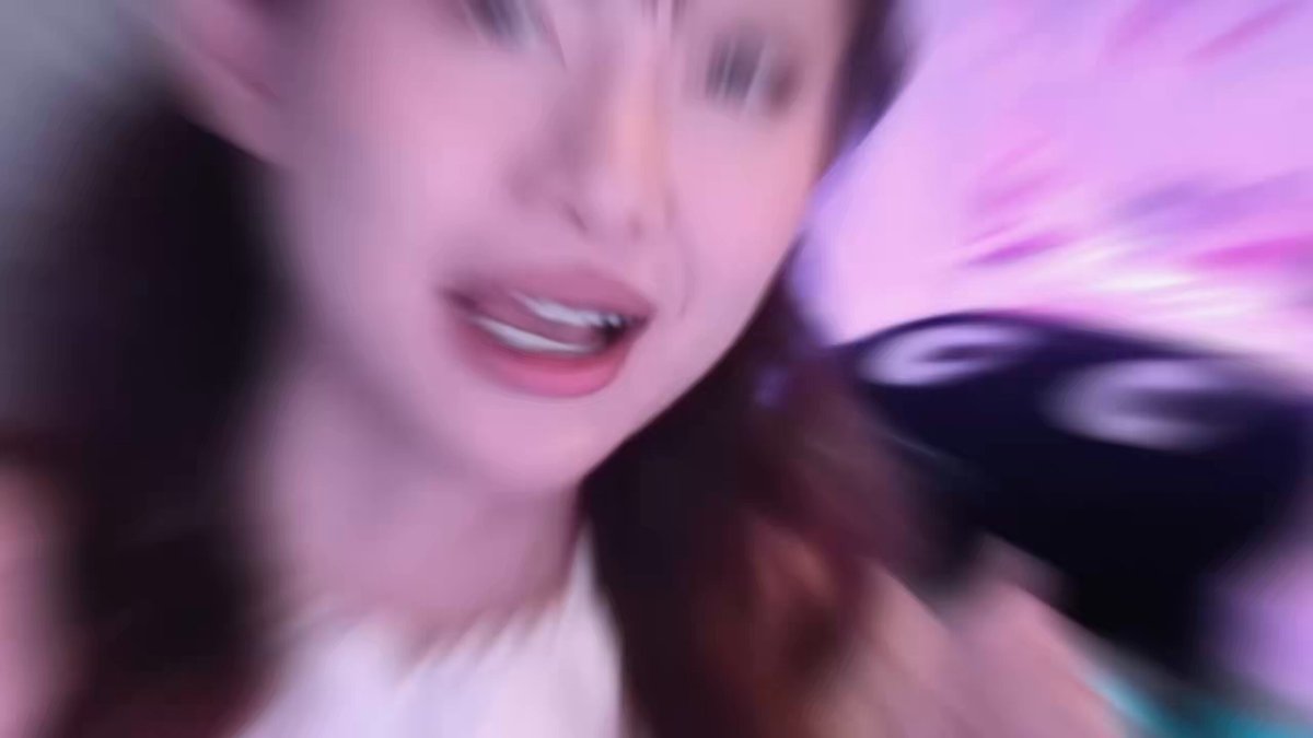 The image features a woman with long brown hair, wearing a white shirt, holding a black object that appears to be a microphone or megaphone. The background of the photo has purple and pink colors, which may suggest an indoor setting like a party or event. The caption on the image reads "another month, another massive build update from @NakamotoGames the team keeps shipping, expanding, and building across the entire ecosystem NAKA'S Backend & Web2 ദ്ദി( • ᴗ < ) ദ്ദി( )".