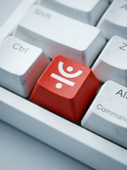 A close-up shot of a white computer keyboard featuring a distinctive red key with a white icon resembling a person or stylized character in its center.