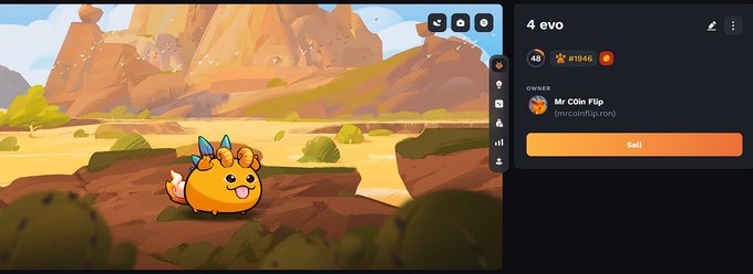 The image shows a cartoon character, possibly a small orange fish or a frog, sitting on rocks with mountains in the background. The character appears to be facing towards the right side of the screen. There are two posts displayed on the screen - one is a message from Axie Infinity, and the other is a post about joining an online game called "Axie Infinity".