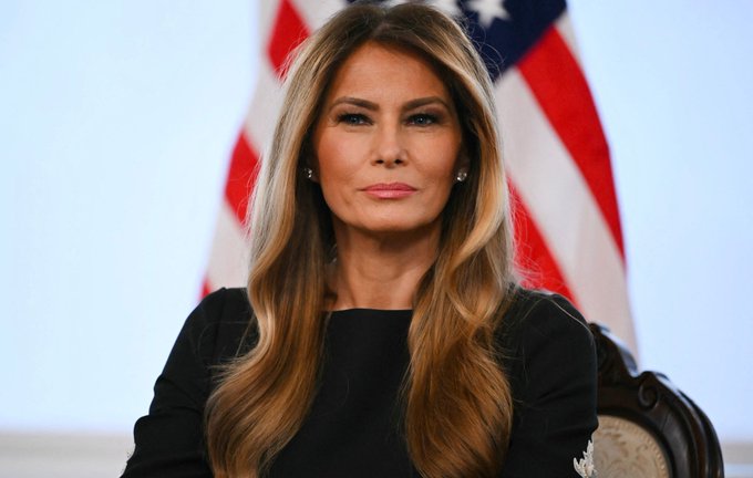 Melania Trump sits before an American flag in a composed, formal portrait, while the accompanying post highlights the dramatic crash of the $MELANIA memecoin, which has lost nearly all of its value despite her public profile.