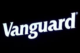 The image displays the bold white "Vanguard" logo on a black background, visually anchoring the brand mentioned in the post about Vanguard's strategic interest in digital assets and crypto infrastructure.