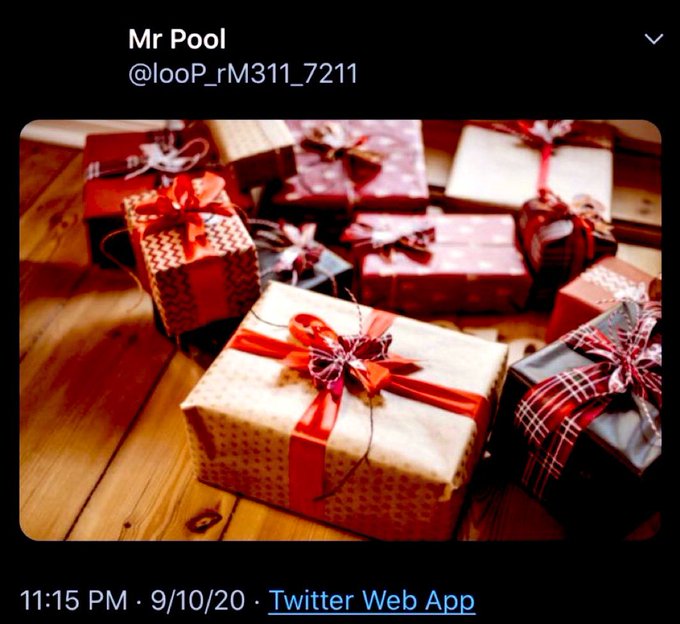 A tweet from "Mr Pool" (@looP_rM311_7211) posted at 11:15 PM on 9/10/20 shows a cluster of wrapped Christmas presents with red ribbons on a wooden floor, which the user uses to symbolically connect the date 09/10 (Christmas Eve) with 09/11 as Christmas morning, suggesting XRP's price will "moon" as a holiday gift.