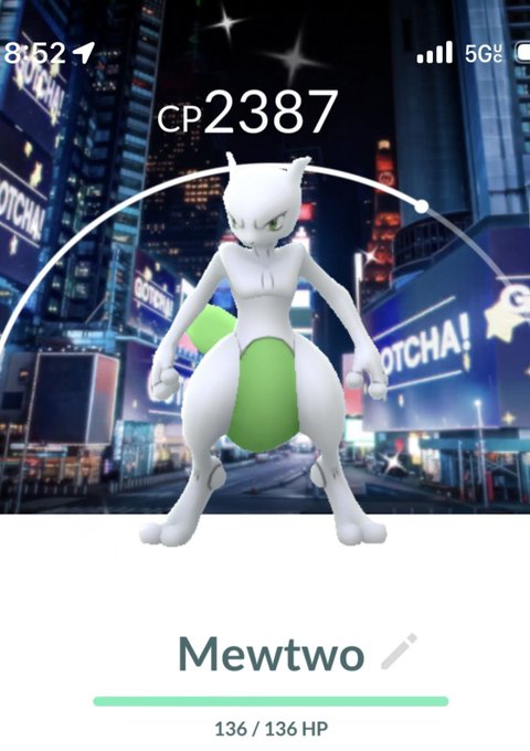 A screenshot from Pokémon GO shows a Mewtwo with a CP of 2387 and full HP of 136/136 against a neon cityscape backdrop, supporting the post's claim that the encounter appears to be a shiny (rare) version of the typically purple Psychic-type Legendary Pokémon.