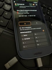 A smartphone displays a Ramp.network app screen prompting to enter an amount to buy crypto, sitting on a black keyboard surface.