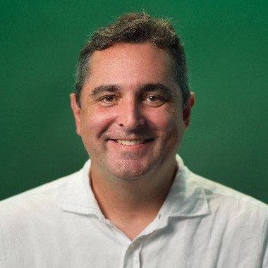 The image shows a smiling middle-aged man with short dark hair, wearing a white polo shirt against a green background, who appears to be Mike Dudas, the crypto VC and Managing Partner of 6th Man Ventures referenced in the post as $TOAD's biggest holder.