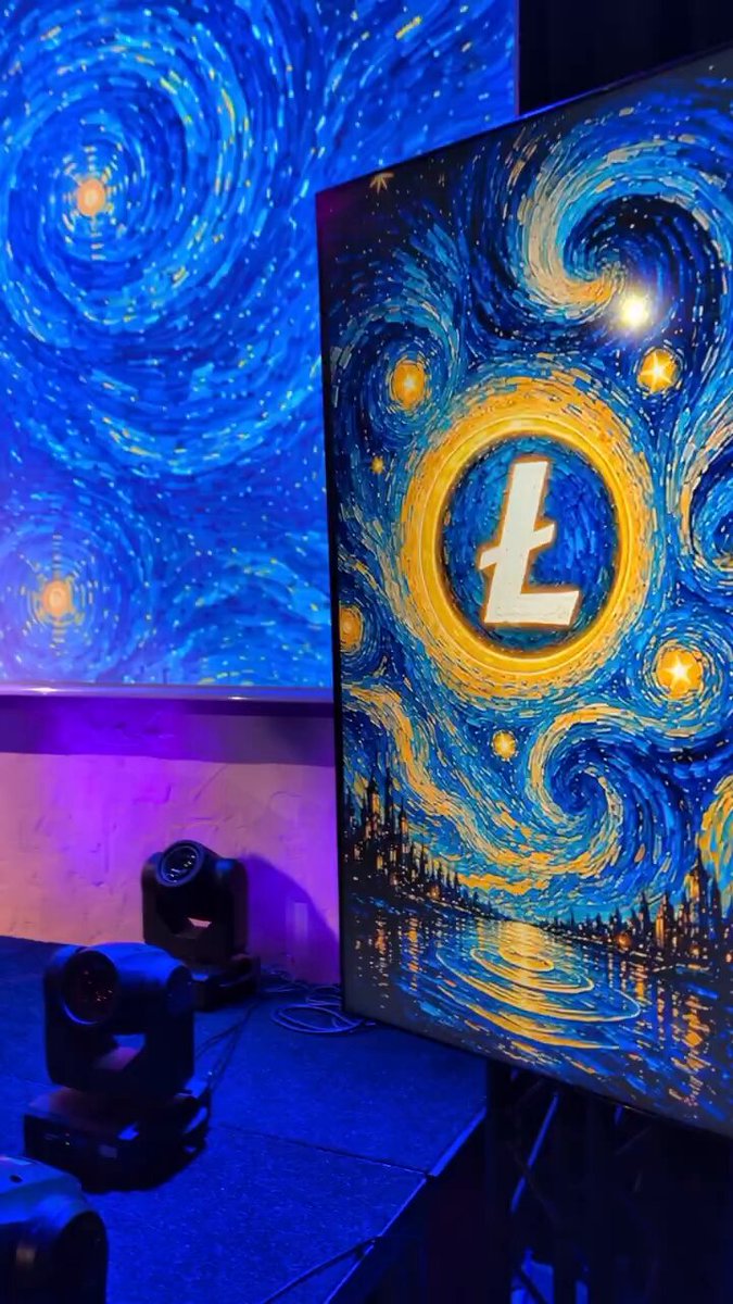 The image features a large painting of a starry night sky with blue swirls, which appears to be a digital art piece or an illuminated poster. The painting is displayed against a dark background, making it stand out prominently. In front of this artwork, there are two speakers and a light source positioned on the left side of the image. A caption below the painting reads "@LitVM party gonna be".