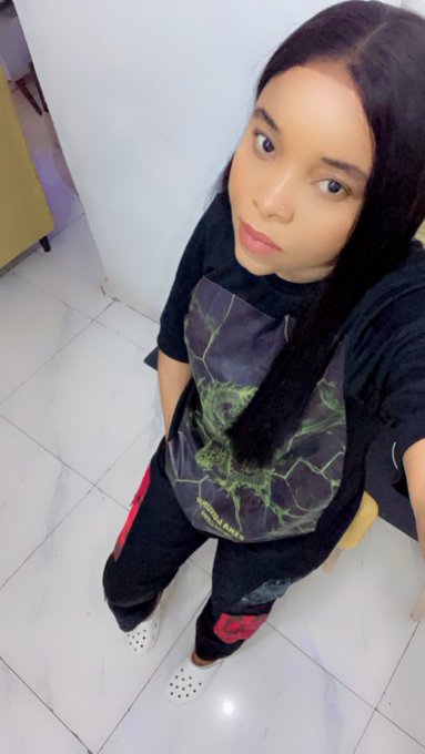 In this image, a young woman dressed in black stands on a tiled floor and looks very serious as she does a selfie. The accompanying post talks about waiting for a next market take, which may suggest that the picture is taken after a financial crisis.