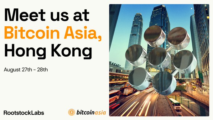 A promotional graphic for Bitcoin Asia in Hong Kong (August 27th–28th), featuring an image of metallic cylindrical objects overlaid on a cityscape, with the RootstockLabs and Bitcoin Asia logos at the bottom. The image supports the post by visually announcing Rootstock Labs' upcoming attendance at the Bitcoin Asia conference in Hong Kong.
