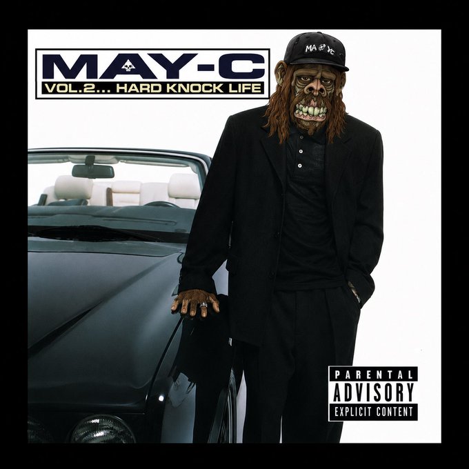 The image is an album/mixtape cover titled "MAY-C VOL. 2... HARD KNOCK LIFE" featuring a masked figure in a black suit and "MAY-C" cap leaning against a black convertible, with a "Parental Advisory Explicit Content" label in the corner. The post ties to the cover thematically, announcing a move back to Brooklyn for "Volume 2" of the poster's life, echoing the mixtape's "Hard Knock Life" title.