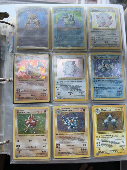 A page of vintage Pokémon cards displayed in a binder, featuring holographic and standard cards including Hitmonchan (70 HP), Machamp (100 HP), Magneton (60 HP), Poliwrath (90 HP), Chansey (120 HP), and others with attacks like "Jab," "Special Punch," "Seismic Toss," and "Thunder Wave." The post references using EmblemVault to wrap these collectible cards for deposit, fitting the theme of "From wise boy to a sage" with cards like Kadabra and Alakazam representing wisdom.