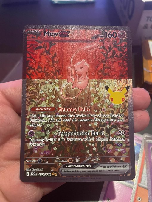 A hand holds a holographic "Mew EX" Pokémon card (#152/128, 160 HP) from the Cosmic Eclipse set, featuring the "Memory Helix" ability and "Teleportation Burst" attack. The card's artwork appears unusually faded or "stoned," matching the caption's reference to a print error where the image looks washed out or altered.