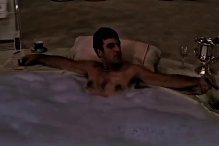 The image shows a shirtless man lying down in a bathtub filled with bubbles, surrounded by various objects such as wine glasses, cups, and a bottle. The scene appears to be set up for a relaxing evening at home or a luxurious spa-like setting. The man is holding a cigarette, which adds an element of leisurely indulgence to the image. The post seems to be discussing the idea that people who become rich suddenly stop talking about their wealth, as evidenced by the man's lack of concern for his appearance and surroundings in this scene.