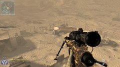 A first-person view from a sniper video game shows a scoped rifle aimed at a desert landscape with buildings.