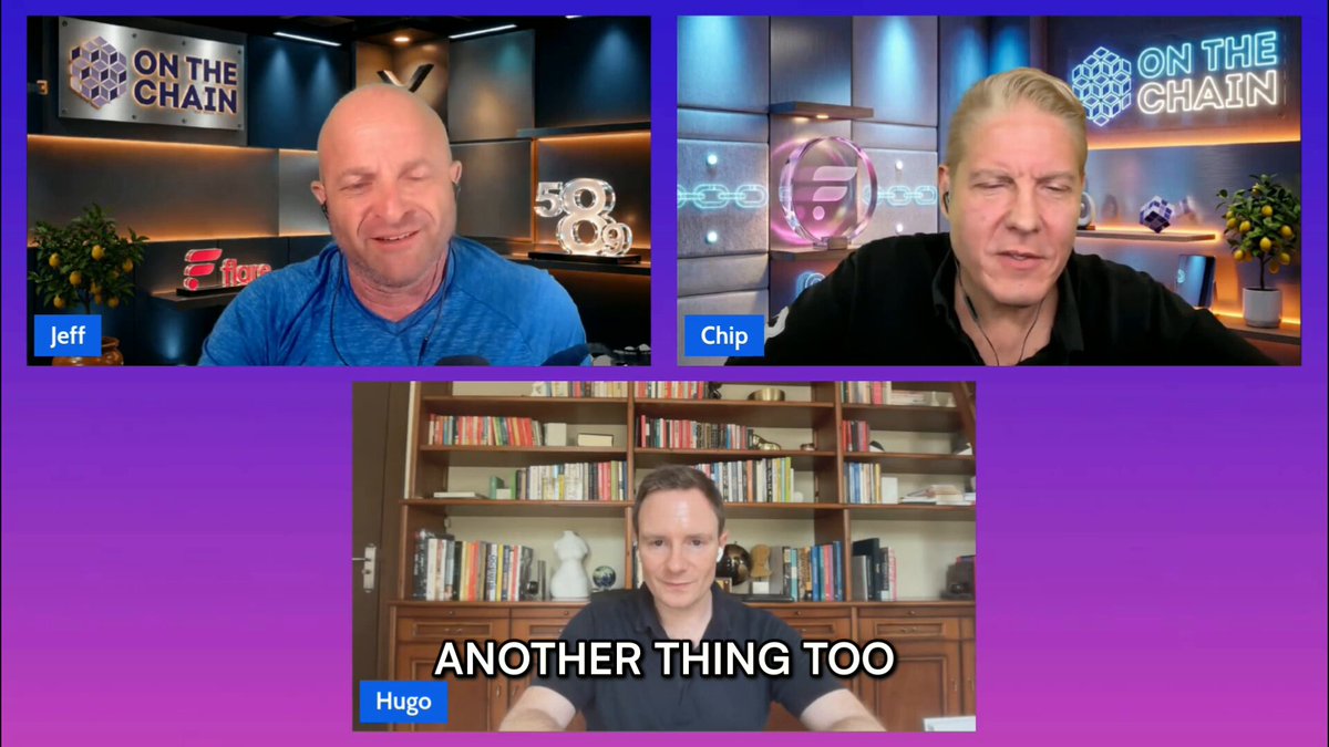 The image shows a video conference call with three people sitting at their desks. They are all smiling as they engage in conversation. In the background of the image, there is a purple wall that has a sign reading "On The Chain". This suggests that the meeting could be related to cryptocurrency or blockchain technology.