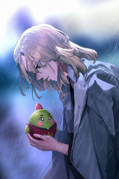 An anime-style illustration shows a person with long hair in a gray coat looking down at a small green plush creature they are holding, while standing in the rain.